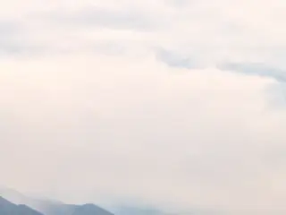 Discover the serene beauty of the Ladakh Pangong Winter Landscape, where tranquility and stillness reign under a pale sky. Experience nature's magic!